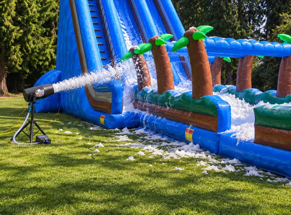 1500W commercial foam machine being used beside a large inflatable bounce house
